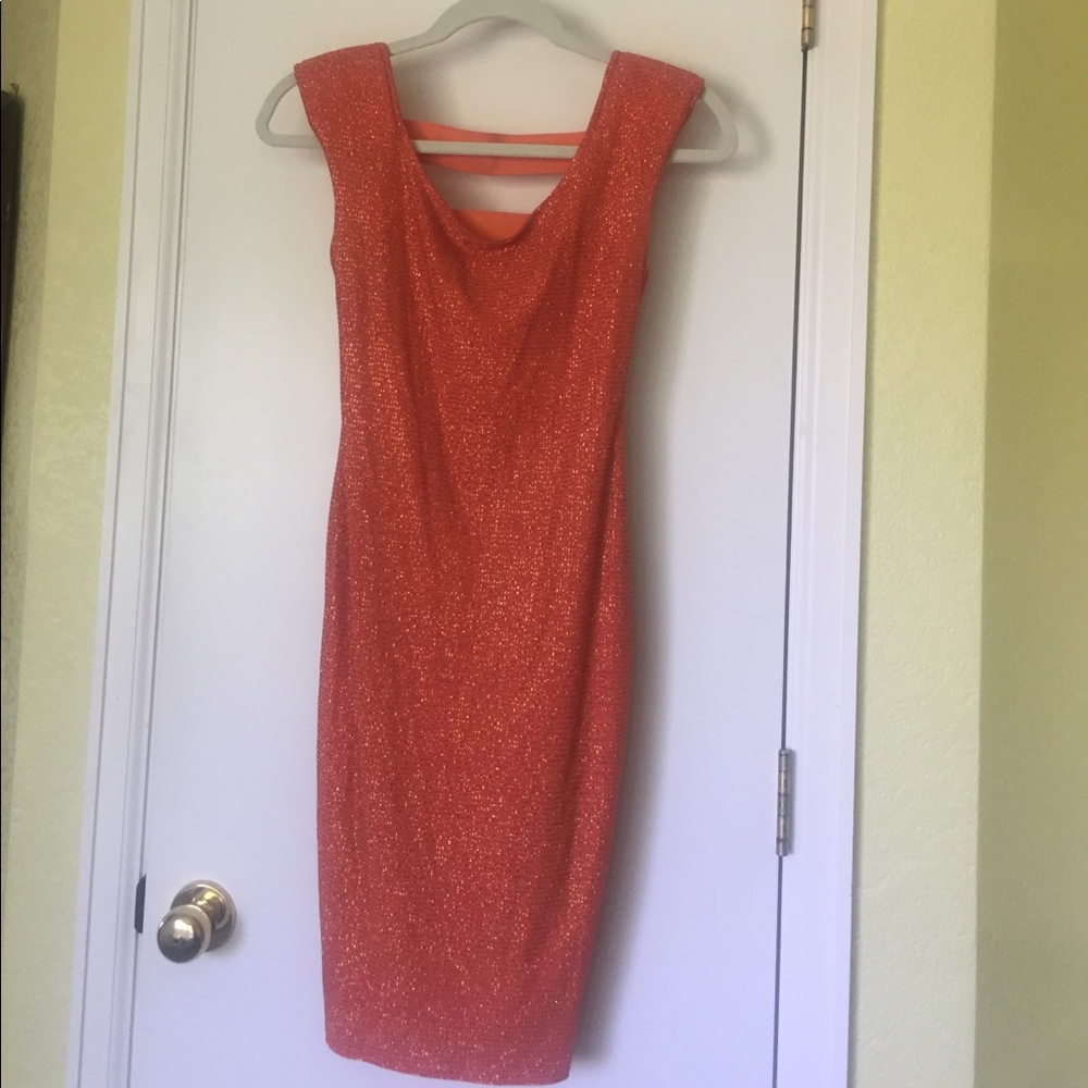 Lovely formal form fitting flattering glitter orange back open panels dress